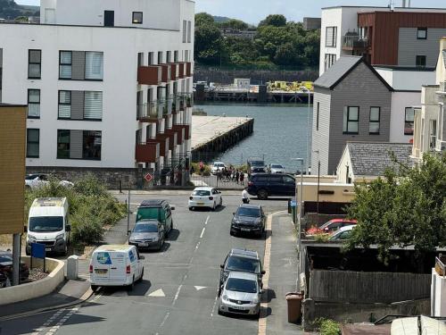 a street with cars parked on the side of a road at Saltram By Pureserviced in Plymouth