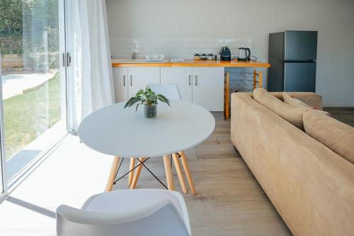 a living room with a white table and a couch at On Helderberg in Somerset West
