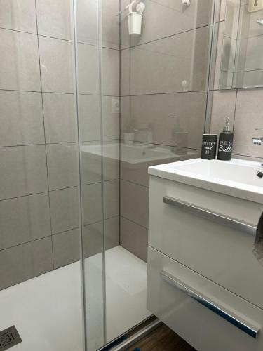 a bathroom with a glass shower and a sink at Studio Paradise entre mer et pins in Saint-Raphaël