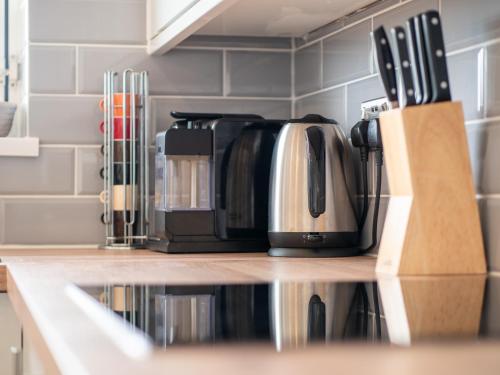 a coffee maker is sitting on a kitchen counter at Stunning 2 bed & 2 bath, Seaview, pets welcome! in Southbourne