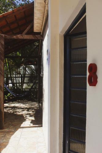 an entrance to a house with a wooden door at Pousada Korui in Abraão