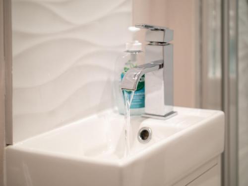 a bathroom sink with a water faucet at Stunning 2 bed & 2 bath, Seaview, pets welcome! in Southbourne