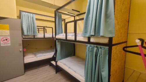 a group of bunk beds in a room at On My Way - Taipei Hostel in Taipei