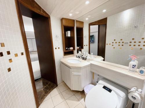 a bathroom with a white toilet and a sink at 所在行旅2館-渡咕所在 UrbanAbode2-DUGU in Taipei