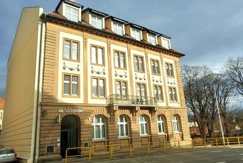 a large building with a balcony on top of it at Apartament Azzurro - Old Town in Kłodzko