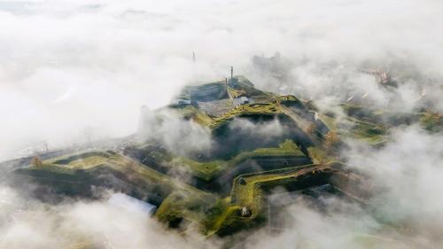 an aerial view of a building in the clouds at Apartament Azzurro - Old Town in Kłodzko