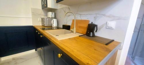 a kitchen with a sink and a coffee maker at Apartament Azzurro - Old Town in Kłodzko