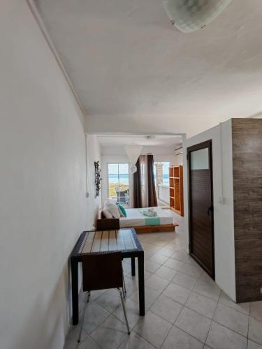 a living room with a table and a bed at Residence Bethel in Rodrigues Island