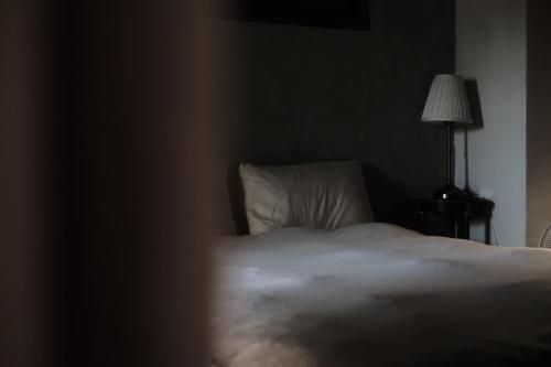 Ένα ή περισσότερα κρεβάτια σε δωμάτιο στο Dwell in Quemoy Homestay