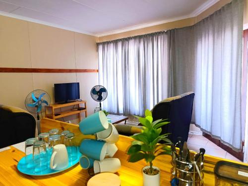 a living room with a wooden table and a dining room at Angelina Victoria Overnight in Colesberg