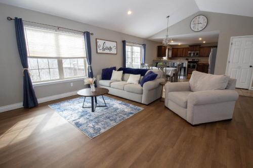 a living room with two couches and a table at Gateway Retreat 27 miles to Fort Leonard Wood in Saint Robert