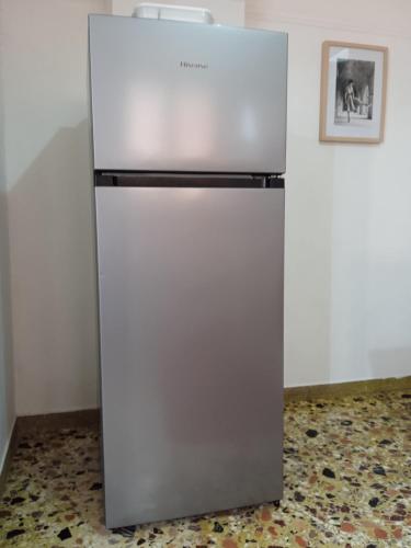 a refrigerator in a room with a picture on the wall at Serene Country House (near Ancient Tiryns) in Nafplio