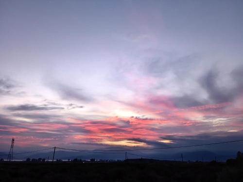 a cloudy sky with a sunset in the sky at Serene Country House (near Ancient Tiryns) in Nafplio