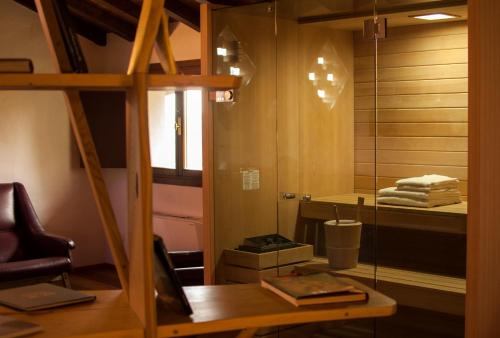 a room with a mirror and a chair and a table at La Lepre Bianca in Cento