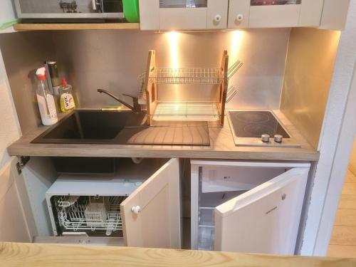 a small kitchen with a sink and a sink at 2 pièces cosy la Foux d 'Allos centre station 30 m carrés in Allos