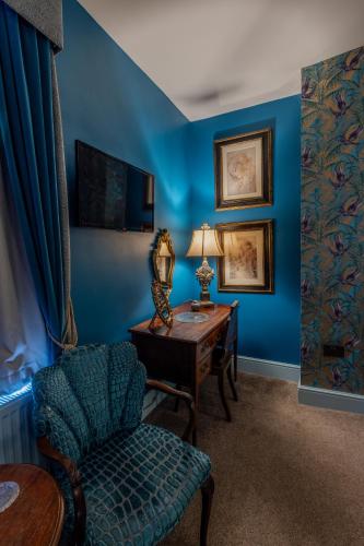 a blue room with a desk and a chair at The Plough Inn in York