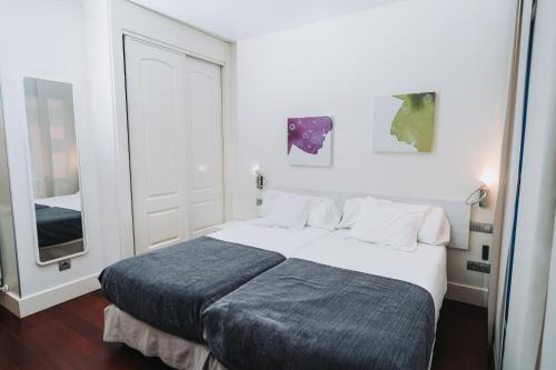 Postel nebo postele na pokoji v ubytování Hostal Acuarela