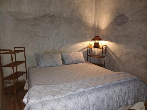 a bedroom with a bed with a white comforter at Fahad Calm House in Ban Not (1)