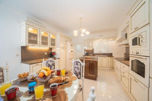 a large kitchen with a table with fruit on it at Irene Luxury Villa in Metaxáta
