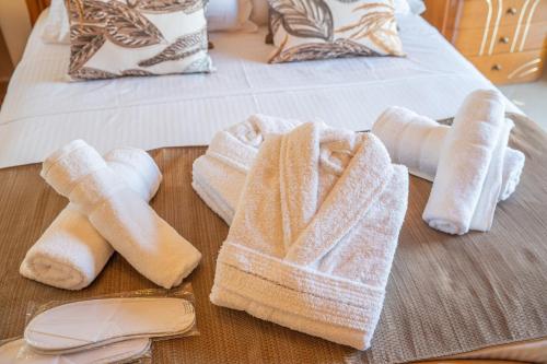 a wooden tray with towels on a bed at Irene Luxury Villa in Metaxáta
