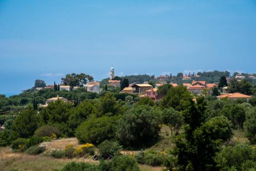 a town on top of a hill with trees at Irene Luxury Villa in Metaxáta