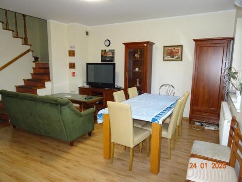 a living room with a table and a couch at Wynajem pokoi Białystok in Białystok