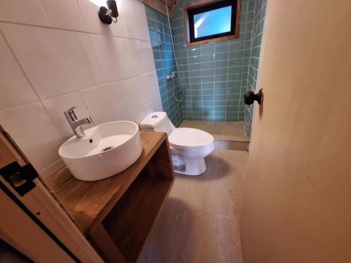a bathroom with a sink and a toilet at Acuarela minicasas con piscina en Lago Vichuquen in Vichuquén