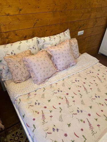 a bed with pillows on top of it at Dom Na Wsi ,, Koszelówka " in Koszele