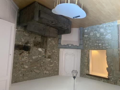 a kitchen with a stone wall and a light at Grand Studio Historique 30m2 - hypercentre in Chambéry