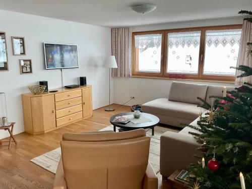 a living room with a christmas tree in it at Ferienwohnung Schoppernau in Schoppernau