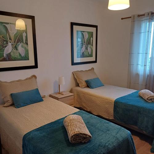 a room with two beds with blue sheets at Casa Miradouro in Ribeira Grande