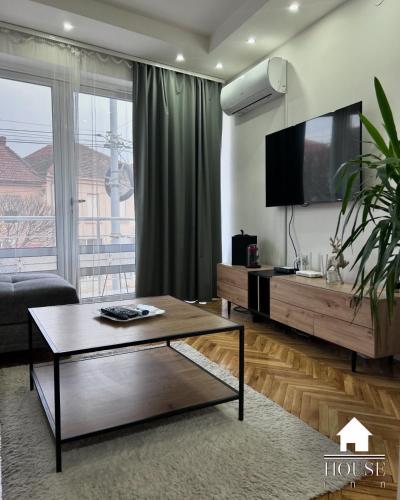 a living room with a tv and a coffee table at House Inn in Pirot