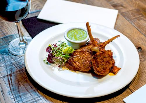 a plate of food on a table with a glass of wine at The Kings Head Hotel in Abergavenny