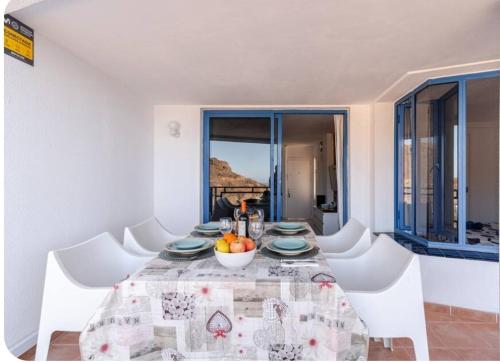 a dining room with a table with a bowl of fruit on it at Roby&Vito Vista Taurito in Taurito