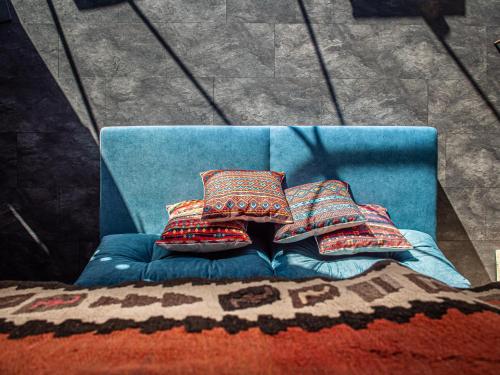 a blue couch with two pillows on it at BUNNY GLAMP in Korbielów