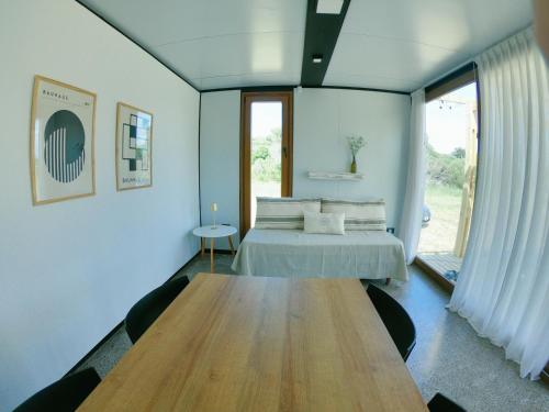 a bedroom with a bed and a wooden table at Serena in Mar de las Pampas