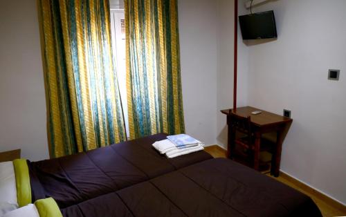 Ένα ή περισσότερα κρεβάτια σε δωμάτιο στο Hostal Muralla