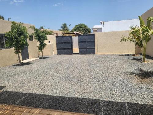 a driveway of a house with a garage at Villa luxueuse à ngaparou saly center in Ngaparou