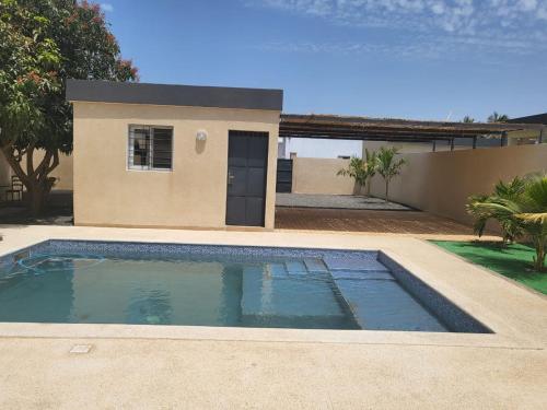 a small swimming pool in front of a house at Villa luxueuse à ngaparou saly center in Ngaparou