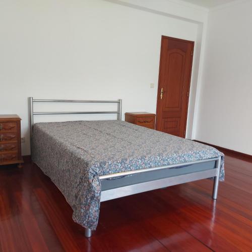 a bedroom with a bed and a wooden floor at Apartment Casa Abundancia Grande in Vila Nova de Poiares