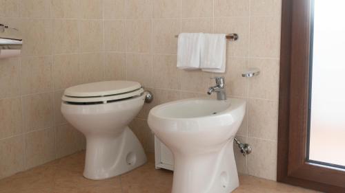 a bathroom with a toilet and a sink at La Casa di Asia in Tanaunella