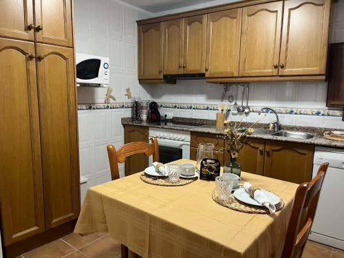 a kitchen with a table with chairs and a tableablish at CASA RURAL MASIA ARINESA Culla in Culla