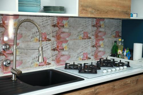 a kitchen counter with a sink and a counter top at Nensica in Vukovar