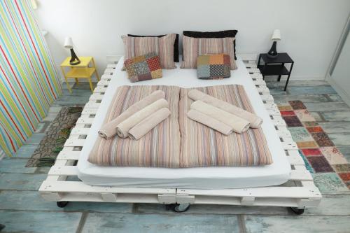 a white bed with pillows on it in a room at Nensica in Vukovar