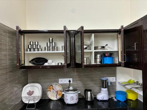 a kitchen with a counter top with cabinets and appliances at Annamaiah Premium & Grand - 2 & 3 BHK Apartments for Families - Homestay & Home Food Service in Tirupati
