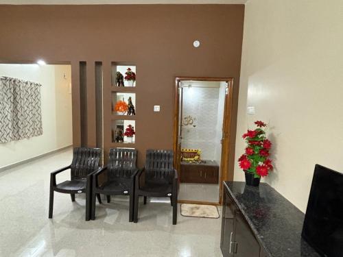 a room with a table and chairs and a mirror at Annamaiah Premium & Grand - 2 & 3 BHK Apartments for Families - Homestay & Home Food Service in Tirupati