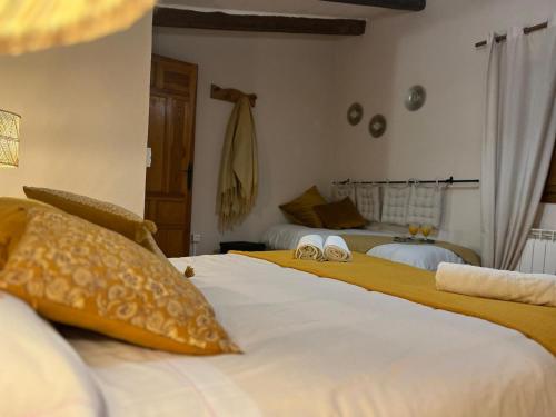 a bedroom with two beds with yellow pillows at CASA RURAL MASIA ARINESA Culla in Culla