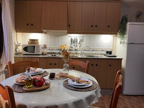 a kitchen with a table with food on it at CASA RURAL MASIA ARINESA Culla in Culla