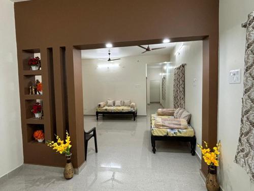 a room with two beds and a mirror at Annamaiah Premium & Grand - 2 & 3 BHK Apartments for Families - Homestay & Home Food Service in Tirupati