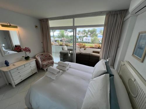 a bedroom with a bed and a large window at MIRAFLORES BEACH&TENNIS AMAZING VIEW BY THE SEA in Sitio de Calahonda